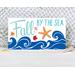 This whimsical autumn-themed coastal sign with bright blue waves, fall leaves, and an orange resin starfish for your coastal fall decor.